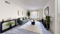 Located in Roswell, GA, this single-floor, three-bedroom, three-bathroom home offers a practical and comfortable layout with a bright, neutral aesthetic throughout. The living room is a welcoming space featuring large windows that invite natural light, light-toned vinyl plank flooring, and a textured ceiling, creating an open and airy ambiance. Adjacent to the living area, the dining room features a ceiling fan with light fixture, the same durable flooring, and a chair rail accent along the walls, with direct access to the kitchen through louvered doors. The kitchen is outfitted with white cabinetry, laminate countertops, a full suite of white appliances including a range, dishwasher, and refrigerator, and a window above the sink that brings in additional natural light. The three bedrooms are carpeted for warmth and comfort, with the generously sized primary bedroom offering notable square footage and closet access. Hallways connect the bedrooms efficiently, finished with the same light vinyl flooring seen throughout the common areas. The three bathrooms include speckled countertop vanities with large mirrors and tiled tub-shower combinations with windows for ventilation. Two closets provide additional storage within this well-organized, functional home.