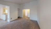Located at 1809 105th Street Ct, Unit H304, in Tacoma, WA 98444, this single-floor residence offers a functional and comfortable layout designed for everyday living. The floor plan reveals multiple rooms connected by a central hallway, providing a clear sense of organization and flow throughout the space.

The bedrooms are finished with wall-to-wall carpet and crisp white walls, creating a clean, neutral canvas. Each room benefits from windows fitted with blinds that invite natural light while maintaining privacy. Baseboard heating units are present in the bedrooms, ensuring consistent warmth. One bedroom features vaulted or elevated ceilings, adding a sense of openness to the space, along with built-in shelving for convenient storage.

The kitchen stands out as a well-appointed area with white shaker-style cabinetry, stainless steel appliances including a refrigerator and electric range, and a double-basin stainless steel sink. Wood-look flooring and warm overhead lighting give the kitchen a bright, welcoming feel.

The living area is generously proportioned with high ceilings, built-in shelving, and plush carpeting, offering a versatile space for relaxing or entertaining. The overall ambiance of the unit is light, airy, and move-in ready, with a consistent neutral palette tying the rooms together seamlessly.