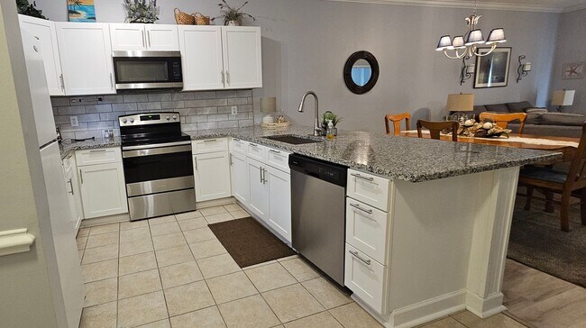 Building Photo - Stunning First-Floor, Fully Furnished Condo with Pond Views