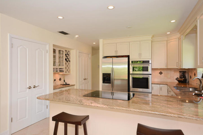Stainless steel appliances and built-in cabinets with 2 pantries - 4100 NW 25th Way