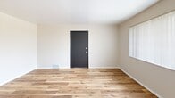 Located at 3209 Cross Keys Dr in Florissant, MO, this single-floor, one-bedroom, one-bathroom unit offers a practical and efficiently organized layout. The living room serves as the entry point, featuring warm wood-look hard-surface flooring, neutral beige walls, and a bold black front door that adds a modern contrast. A window with vertical blinds allows natural light to fill the space, creating a bright and welcoming atmosphere.

The kitchen is positioned adjacent to the living area and continues the wood-look flooring. It includes light wood cabinetry, a tile backsplash, granite-style countertops, a stainless steel range, and a sink. A large window with vertical blinds brightens the kitchen, making it a functional and pleasant workspace.

The bedroom offers a comfortable footprint with soft carpeting, a sliding-door closet, and a window overlooking outdoor greenery, contributing natural light and a sense of openness. A second carpeted room, accessible via a separate door, provides additional flexible space.

The bathroom features wood-look flooring, partial tile wall accents, a white tub-shower combination, and a clean, straightforward design. Overall, the unit maintains a consistent neutral palette throughout, offering a simple, functional living environment.