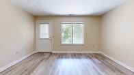 Located at 4172 Bridgewater Pkwy in Stow, Ohio, this 2-bedroom, 1-bathroom residence offers a practical and comfortable single-floor layout. The open living room is bright and welcoming, featuring light wood-look flooring, neutral warm-toned walls, and large sliding windows that fill the space with natural light and offer views of surrounding greenery. A front entry door with a window provides additional light and easy outdoor access. The kitchen is efficiently designed with white cabinetry, wood-accented trim, light countertops, and a Whirlpool electric range with an overhead microwave, all set on durable wood-look flooring. Both bedrooms are carpeted for comfort, with the spacious primary bedroom offering ample room for furnishings and featuring a closet with bi-fold doors. The second bedroom also includes a sliding window, bringing in natural light. The full bathroom is clean and functional, complete with a tub/shower combo, a single-sink vanity, and wood-look flooring. A hallway connects the bedrooms and bathroom, providing a logical and efficient flow throughout the residence. The overall aesthetic is clean, neutral, and move-in ready.