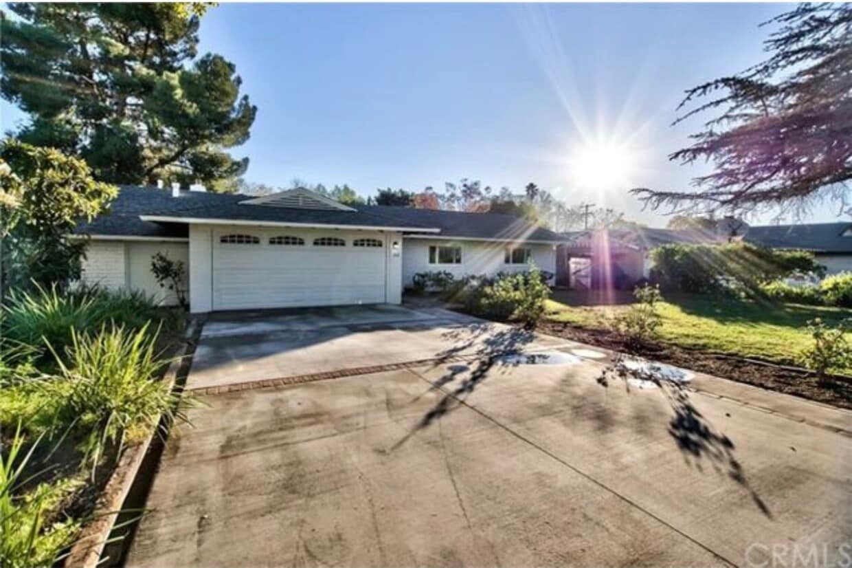 Charming mid-century brick home with inviting curb appeal, mature trees, and a spacious front yard - 332 E Deodar St