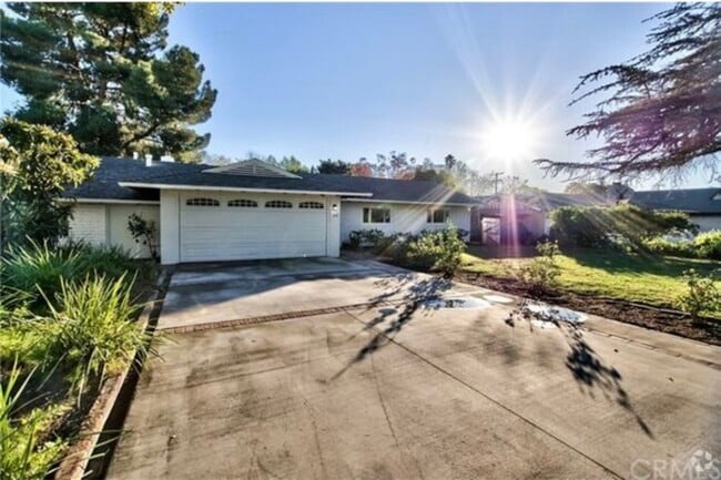 Charming mid-century brick home with inviting curb appeal, mature trees, and a spacious front yard - 332 E Deodar St