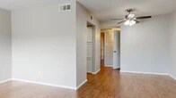 Located at 2200 W Lowden St in Fort Worth, TX, this single-story, one-bedroom, one-bathroom residence offers a practical and comfortable layout across a thoughtfully organized floor plan. Wood-look flooring runs throughout the space, providing a warm and cohesive aesthetic from room to room.

The living room is bright and open, featuring a ceiling fan with light fixture and a large window fitted with horizontal blinds that invite natural light and provide views of the surrounding area. Neutral gray walls and clean white trim give the space a fresh, move-in-ready feel.

The kitchen is efficiently designed with white cabinetry, granite-look countertops, and an appliance suite that includes a stainless steel range and a dishwasher. The patterned tile flooring adds visual distinction to the cooking area.

A hallway with built-in shelving connects the main living area to the bedroom and bathroom. The spacious primary bedroom includes a ceiling fan, a window for natural light, and access to a walk-in closet offering generous storage. A secondary closet is also visible in the room.

The bathroom features wood-look flooring, a full bathtub with large-format tile surround, a toilet, and a vanity with matching granite-look countertops and white cabinetry, consistent with the rest of the unit's finishes.