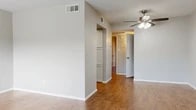Located at 2200 W Lowden St in Fort Worth, TX, this single-story, one-bedroom, one-bathroom residence offers a practical and comfortable layout across a thoughtfully organized floor plan. Wood-look flooring runs throughout the space, providing a warm and cohesive aesthetic from room to room.

The living room is bright and open, featuring a ceiling fan with light fixture and a large window fitted with horizontal blinds that invite natural light and provide views of the surrounding area. Neutral gray walls and clean white trim give the space a fresh, move-in-ready feel.

The kitchen is efficiently designed with white cabinetry, granite-look countertops, and an appliance suite that includes a stainless steel range and a dishwasher. The patterned tile flooring adds visual distinction to the cooking area.

A hallway with built-in shelving connects the main living area to the bedroom and bathroom. The spacious primary bedroom includes a ceiling fan, a window for natural light, and access to a walk-in closet offering generous storage. A secondary closet is also visible in the room.

The bathroom features wood-look flooring, a full bathtub with large-format tile surround, a toilet, and a vanity with matching granite-look countertops and white cabinetry, consistent with the rest of the unit's finishes.