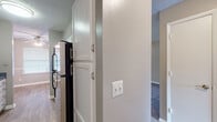 Located at 103 Echo Glen Dr in Winston-Salem, NC, this single-story, one-bedroom, one-bathroom home offers a well-organized layout across a compact yet functional floor plan. The interior features neutral taupe-toned walls throughout, textured ceilings, and a consistent color palette that creates a cohesive ambiance.

The combined kitchen and living room area serves as the heart of the home. The kitchen is equipped with white upper cabinetry featuring brushed nickel hardware, dark speckled countertops, and wood-look vinyl flooring. A pass-through opening connects the kitchen to the adjacent living space, enhancing the open feel.

The dining room is a dedicated space with warm hardwood-style flooring, a ceiling fan with light fixture, and a window fitted with blinds that allows natural light to filter in. Chair rail molding adds a touch of architectural detail to the walls.

The generously sized bedroom is carpeted and features two closets — one with bifold doors and another with a standard hinged door — offering ample storage. The room receives natural light and connects conveniently to the rest of the unit.

The bathroom includes a full-size soaking tub with a shower and curtain rod, finished in clean white surround panels. Throughout the home, plush carpet in the bedroom and living areas contrasts with the hard-surface flooring in the kitchen and dining room.
