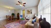 Located at 2828 Marblevista Blvd in Columbus, Ohio, this single-floor home offers a well-organized layout with comfortable living spaces throughout. The living room serves as the heart of the home, featuring rich hardwood flooring, large windows that invite abundant natural light, a ceiling fan, and a tile-surround fireplace beneath a mounted TV — creating a warm and inviting atmosphere. Adjacent to the living area, the dining space accommodates a full table and chairs beneath a classic pendant light, continuing the hardwood floor aesthetic. The kitchen is thoughtfully designed with white cabinetry, a breakfast bar with bar seating, stainless steel appliances, recessed lighting, and durable hardwood floors that tie the space together seamlessly. A separate entry with tile flooring provides convenient access. The primary bedroom features plush carpeting, a ceiling fan, a window with natural views, and ample room for a king-sized suite. A second bedroom offers carpeted floors and comfortable proportions. The bathroom is finished with large-format tile flooring, a white vanity, and a shower-tub combination. Throughout the home, neutral warm tones and consistent finishes create a cohesive and practical living environment.