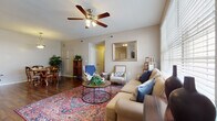 Located at 2828 Marblevista Blvd in Columbus, Ohio, this single-floor home offers a well-organized layout with comfortable living spaces throughout. The living room serves as the heart of the home, featuring rich hardwood flooring, large windows that invite abundant natural light, a ceiling fan, and a tile-surround fireplace beneath a mounted TV — creating a warm and inviting atmosphere. Adjacent to the living area, the dining space accommodates a full table and chairs beneath a classic pendant light, continuing the hardwood floor aesthetic. The kitchen is thoughtfully designed with white cabinetry, a breakfast bar with bar seating, stainless steel appliances, recessed lighting, and durable hardwood floors that tie the space together seamlessly. A separate entry with tile flooring provides convenient access. The primary bedroom features plush carpeting, a ceiling fan, a window with natural views, and ample room for a king-sized suite. A second bedroom offers carpeted floors and comfortable proportions. The bathroom is finished with large-format tile flooring, a white vanity, and a shower-tub combination. Throughout the home, neutral warm tones and consistent finishes create a cohesive and practical living environment.