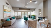 Located at 7566 Greenback Ln in Citrus Heights, California, this well-appointed single-floor residence offers a thoughtfully designed open-concept layout that seamlessly connects the kitchen and living areas. The living room is a standout, boasting soaring vaulted ceilings that lend an airy, expansive feel to the space. A sleek fireplace serves as a striking focal point, flanked by large sliding glass doors that invite natural light and provide access to an outdoor patio area with views of the surrounding landscape. Wood-look flooring flows throughout, adding warmth and continuity to the interior. The kitchen is efficiently designed and fully equipped with stainless steel appliances, including a refrigerator, range, and built-in microwave. Crisp white cabinetry provides ample storage, while a white countertop breakfast bar with seating offers a casual dining option and serves as a natural divider between the kitchen and living spaces. The neutral color palette of soft whites and warm grays throughout the home creates a clean, modern backdrop, complemented by stylish accents. The overall ambiance is bright, contemporary, and inviting, making this Citrus Heights residence a comfortable and functional living space.