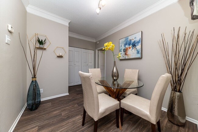 Dining area with hardwood-style flooring - The Indigo at Grissom