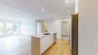 This well-appointed 2-bedroom, 2-bathroom unit in Enfield, Nova Scotia offers a thoughtfully designed single-floor layout that maximizes both function and comfort. The open-concept kitchen and living area serves as the heart of the home, anchored by a central island with a built-in sink, white cabinetry with warm wood accents, and a full suite of stainless steel appliances including a refrigerator, stove, microwave, and dishwasher. Light-toned hardwood flooring flows seamlessly throughout the main living areas, complementing the clean, bright aesthetic created by crisp white walls and recessed lighting. The spacious living room is bathed in natural light through large sliding windows that frame outdoor views. Both bedrooms are generously sized, each featuring large windows with exterior views and the same warm hardwood flooring. The primary bedroom benefits from a well-organized walk-in closet with built-in shelving and hanging rails. The two bathrooms are finished with light tile flooring, wood-toned vanities, stone countertops, and tub-shower combinations. A dedicated in-unit laundry room houses a stacked Whirlpool washer and dryer. The unit also includes a wall-mounted mini-split system and baseboard heating throughout.