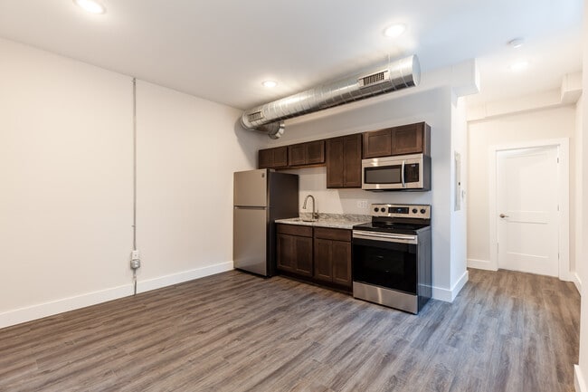 Granite counters, easy to care for luxury vinyl plank flooring, wood cabinetry. - 722 E McMillan St