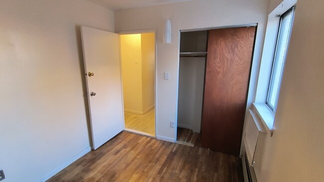 Bedroom #1 with closet and window w/ AC unit - 323 Avenue C