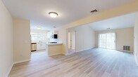 Located at 39 Buckland St in Manchester, CT, this single-floor, 2-bedroom, 2-bathroom home offers a bright and functional layout designed for comfortable everyday living. The open-concept living and kitchen area serves as the heart of the home, featuring light wood-tone flooring, warm neutral walls, and a vaulted ceiling in the living room that adds a sense of volume and airiness. Large sliding glass doors fill the living space with natural light and provide outdoor access. The kitchen is well-appointed with white shaker-style cabinetry, light countertops, a peninsula with a breakfast bar overhang, and a full suite of stainless steel appliances including a refrigerator, dishwasher, microwave, and gas range. A window above the sink brings in additional natural light. Both bedrooms are generously sized with plush carpeting and multiple windows that overlook greenery outside. The spacious primary bedroom features two windows, offering ample natural light. Both bathrooms are finished with large-format neutral tile flooring and tub-shower combinations with full tile surrounds, white vanities, and brushed nickel fixtures. A hallway connects the bedroom and bathroom wing, completing this clean, move-in-ready home.