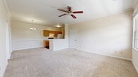 Located at 2011 Aspen Pines Dr in Wilder, Kentucky, this single-floor residence offers a thoughtfully arranged layout across a comfortable footprint. The open-concept living and dining area forms the heart of the home, featuring neutral-toned carpet, a ceiling fan, and a stylish chandelier that together create a bright and welcoming atmosphere. The kitchen connects seamlessly to the main living space and is outfitted with warm oak cabinetry, gray laminate countertops, hardwood-style flooring, a stainless steel sink, dishwasher, electric range, and a full-size refrigerator — providing ample functionality for everyday cooking. Crown molding adds a refined touch throughout.

The generously sized bedroom is a private retreat, complete with plush carpeting, a ceiling fan, and a large window that invites natural light and offers pleasant outdoor views of surrounding greenery. A dedicated walk-in closet with built-in wire shelving provides extensive storage. The full bathroom is finished with a wood-toned vanity, white countertop, a tub-shower combo, and hardwood-style flooring. A utility room rounds out the layout, adding practical convenience. Clean lines, neutral tones, and consistent finishes give this residence a cohesive and move-in-ready appeal.