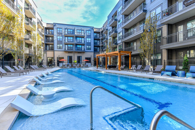 Our pool is complete with a poolside yoga area. - Elevate West Village