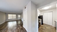 Located at 8050 Taylor Rd in Riverdale, GA, this single-story, one-bedroom, one-bathroom home offers a practical and efficiently designed layout. The open living room is a welcoming focal point, featuring rich wood-look flooring, neutral gray walls, and multiple windows with blinds that allow generous natural light to fill the space. A textured ceiling and clean white baseboards complete the room's tidy, move-in-ready aesthetic. The kitchen is positioned adjacent to the main living area and is equipped with white cabinetry, light speckled countertops, a stainless steel sink, a black dishwasher, a range, and a refrigerator. A window above the counter brings in additional natural light, and a bi-fold closet door provides convenient pantry storage. The bedroom offers comfortable carpeted flooring, soft gray walls, a textured ceiling, a window for natural light, and an open closet with a hanging rod for organized storage. The bathroom is clean and functional, featuring a full tub-shower combination with white tile surround and chrome fixtures. Throughout the home, dark wood-look flooring in the main areas and plush carpet in the bedroom create a cohesive and comfortable living environment.