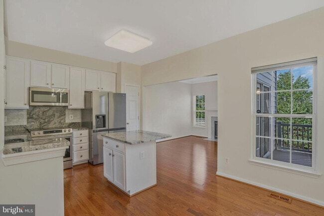 Building Photo - This beautifully maintained brick-front, three-level townhome is located in a highly sought-after...