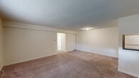 Located at 511 E Gibbsboro Rd in Lindenwold, NJ, this single-floor unit offers a practical and comfortable layout designed for everyday living. The living area is spacious and welcoming, featuring wall-to-wall carpeting, neutral cream-toned walls, and a textured ceiling. A large window with blinds allows natural light to fill the room, while a front entry door with a sidelight panel provides a bright, accessible entrance. The living space connects seamlessly to additional areas via an open passage.

The kitchen is thoughtfully updated, showcasing gray shaker-style cabinetry, dark countertops, and a subtle tile backsplash. White appliances — including a refrigerator, gas range, and dishwasher — are neatly integrated, and light tile flooring completes the clean, functional aesthetic. A pass-through counter opening connects the kitchen to the adjacent living space, enhancing the open feel.

The bedroom is generously sized with plush carpeting, a textured ceiling, and a folding-door closet, offering ample storage. The full bathroom features tile flooring, a tub-shower combination with white tile surround, and clean, minimal fixtures. Throughout the unit, the design is cohesive, bright, and move-in ready.