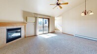 Located at 1405 N McCarthy Rd in Appleton, Wisconsin, this one-bedroom, one-bathroom unit offers a thoughtfully arranged single-floor layout with a comfortable sense of space throughout. The open-concept living, dining, and kitchen area serves as the heart of the home, anchored by a tile-surround fireplace with a wood mantel in the living room and accentuated by vaulted ceilings and a chandelier in the dining area. Natural light fills both spaces through well-placed windows. The kitchen is equipped with warm oak cabinetry, white appliances including a range, dishwasher, and refrigerator, light countertops, and tile flooring that extends into the bathroom. The spacious bedroom features vaulted ceilings, a ceiling fan, plush carpet, and a large walk-in closet with built-in shelving for ample storage — plus an additional closet nearby. The full bathroom includes an oak vanity, tile flooring, and convenient in-unit washer and dryer access tucked behind sliding doors. Additional highlights include multiple closets throughout, a hallway connecting key areas, and a private balcony. Baseboard heating is present throughout the unit, ensuring year-round comfort in the Wisconsin climate.