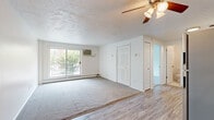 Located at 17920 Detroit Ave in Lakewood, Ohio, this one-bedroom, one-bathroom unit offers a practical and well-appointed layout across a single floor. The open-concept living and kitchen area serves as the heart of the space, where durable wood-look flooring transitions seamlessly into a carpeted living area. A ceiling fan overhead adds comfort, while a textured ceiling provides architectural character. The living room is anchored by a large sliding glass door that opens to a private balcony, flooding the room with natural light and offering views of the surrounding greenery.

The kitchen is efficiently designed with white shaker-style cabinetry, light quartz countertops, a classic subway tile backsplash, and a full suite of stainless steel appliances including a refrigerator, range, microwave, and dishwasher. The bedroom is a comfortable, carpeted retreat featuring a window with a tree-lined outlook and a baseboard heating system. The bathroom has been thoughtfully updated with large-format tile on the tub surround and flooring, a pedestal sink, mirrored medicine cabinet, and a clean, modern finish throughout. Baseboard heating is present throughout the unit, complemented by a wall-mounted A/C unit in the living area.