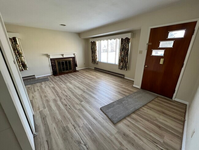 Living room with fireplace and new flooring - 11349 Greenberry Rd