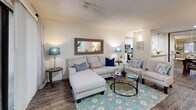 Located in Mesa, AZ, this thoughtfully designed single-story home offers a comfortable and functional layout encompassing one bedroom and two bathrooms. The living room serves as a welcoming focal point, featuring wood-style flooring, a textured ceiling, and a sliding glass door that fills the space with natural light and provides direct access to the outdoors. The adjacent dining area is enhanced by a full-length mirrored wall that amplifies the sense of space, complemented by wood-style flooring throughout. The galley-style kitchen is well-equipped with white shaker cabinetry, white quartz countertops, stainless steel appliances including a range, microwave, refrigerator, and dishwasher, all set atop light wood-style flooring. The bedroom offers a serene retreat with plush carpet, a ceiling fan, and a sliding glass door that opens to an outdoor view. An en-suite bathroom features warm earth-tone tile surrounding a full soaking tub and shower combination. A second full bathroom provides added convenience. A dedicated closet and hallway complete the layout, making this home efficient and practical for everyday living.