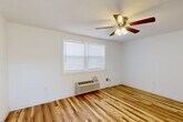 Located at 815 W Buford St in Gaffney, South Carolina, this single-story 2-bedroom, 1-bathroom home offers a practical and comfortable layout designed for efficient everyday living. Warm-toned hardwood flooring flows throughout the bedrooms and hallway, lending a cohesive and inviting feel to the interior.

Both bedrooms are bright and well-proportioned, each featuring a ceiling fan with light fixture, natural light from double-pane windows with blinds, and a dedicated closet with a rod for hanging storage. The primary bedroom also includes a wall-mounted HVAC unit for individual climate control.

The kitchen is equipped with light natural wood cabinetry — both upper and lower — complemented by light granite-style countertops, a stainless steel sink, a black gas range, over-the-range microwave, and a stainless steel refrigerator. White tile flooring and a window above the countertop complete the space, which also provides direct exterior access through a paneled door.

The bathroom features a white vanity with an integrated sink, a mirror, and light tile flooring that coordinates with the clean, neutral palette found throughout the home. A central hallway connects all rooms, providing an organized and efficient flow. The overall aesthetic is clean, bright, and move-in ready.