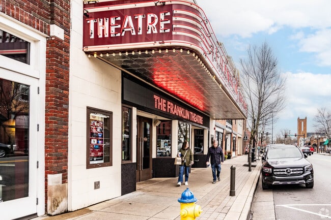 A couple walks past the Historic Franklin Theater.