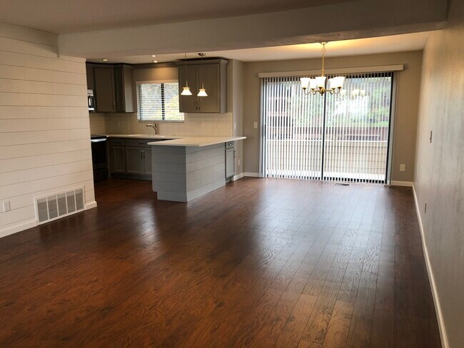 Living Area/Dining area looking at back of unit and sliding door and balcony. - 422 Wright St