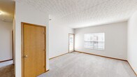 Located at 2680 Silver Oak Dr in Columbus, Ohio, this one-bedroom, one-bathroom single-floor home offers a functional and well-organized layout. The living room is bright and inviting, featuring plush carpeting, warm wood baseboard trim, textured ceilings, and sliding glass doors dressed with vertical blinds that allow natural light to fill the room and provide access to an outdoor area. Adjacent to the living room, the galley-style kitchen is efficiently designed with warm oak cabinetry, white laminate countertops, light wood-look vinyl flooring, and white appliances including a refrigerator, electric range with built-in microwave, and dishwasher. A breakfast bar provides a convenient transition between the kitchen and living areas. The bedroom is generously sized with soft carpeting and windows fitted with blinds for natural light control. It is complemented by a dedicated walk-in closet outfitted with multiple wire shelving units, offering ample storage. The full bathroom features an oak vanity with a white countertop and single-basin sink, a lighted mirror, and a tub-shower combination. A hallway connects the main living areas, completing this practical and comfortable single-floor home.
