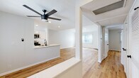 Located on Glendon Avenue in the heart of West Los Angeles, this thoughtfully renovated single-floor residence blends clean, modern design with warm, inviting finishes. Wide-plank hardwood-style flooring runs continuously throughout every room, creating a cohesive and airy feel across the entire layout.

The open-concept living and dining area is anchored by a classic fireplace and bathed in natural light through large windows dressed with vertical blinds. The space flows directly into the kitchen, which features white shaker-style cabinetry with matte black hardware, quartz countertops, stainless steel appliances including a gas range and built-in microwave, and a peninsula with a sink — ideal for both cooking and casual entertaining. A ceiling fan overhead adds comfort to the shared living space.

The bedrooms are generously proportioned, each finished with the same warm flooring and neutral gray-white walls. Multiple closets, including a double-door closet and a louvered utility closet, offer ample storage in the hallway.

The bathroom is elegantly appointed with a white vanity, quartz countertop, matte black fixtures, a round mirror with modern sconce lighting, mirrored sliding closet doors, and a full tub-shower combination. Recessed lighting and ceiling vents throughout ensure comfort and functionality in every corner of this polished West LA residence.