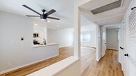 Located on Glendon Avenue in the heart of West Los Angeles, this thoughtfully renovated single-floor residence blends clean, modern design with warm, inviting finishes. Wide-plank hardwood-style flooring runs continuously throughout every room, creating a cohesive and airy feel across the entire layout.

The open-concept living and dining area is anchored by a classic fireplace and bathed in natural light through large windows dressed with vertical blinds. The space flows directly into the kitchen, which features white shaker-style cabinetry with matte black hardware, quartz countertops, stainless steel appliances including a gas range and built-in microwave, and a peninsula with a sink — ideal for both cooking and casual entertaining. A ceiling fan overhead adds comfort to the shared living space.

The bedrooms are generously proportioned, each finished with the same warm flooring and neutral gray-white walls. Multiple closets, including a double-door closet and a louvered utility closet, offer ample storage in the hallway.

The bathroom is elegantly appointed with a white vanity, quartz countertop, matte black fixtures, a round mirror with modern sconce lighting, mirrored sliding closet doors, and a full tub-shower combination. Recessed lighting and ceiling vents throughout ensure comfort and functionality in every corner of this polished West LA residence.