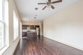 Located in the heart of downtown Montgomery, Alabama, this 2-bedroom, 2-bathroom residence at 79 Commerce St offers a well-appointed single-floor layout with a blend of modern finishes and urban convenience. The open-concept kitchen and living area serves as the centerpiece of the home, featuring rich dark wood cabinetry, granite countertops, a large kitchen island with a stainless steel sink, pendant lighting, and a full suite of stainless steel appliances. Dark hardwood flooring flows throughout the main living areas, adding warmth and continuity. Sliding glass doors lead to a private balcony with direct views of the vibrant downtown streetscape, filling the space with natural light. The primary bedroom is generously sized, complete with a ceiling fan and access to outdoor light through large windows. The second bedroom is carpeted and includes a closet, offering comfortable accommodation. Both bathrooms are finished with neutral tile flooring and tub-shower combinations with tile surrounds and dark wood vanities. A dedicated laundry area and in-unit mechanical systems add to the home's functionality. The overall ambiance is clean, modern, and urban, making it an ideal residence in the heart of Montgomery.