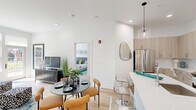 Located at 397 Millburn Ave in Millburn, NJ, this thoughtfully designed one-bedroom, one-bathroom residence offers a seamless blend of modern aesthetics and functional living. The open-concept floor plan connects the kitchen, dining, and living areas into one cohesive, light-filled space, creating an inviting atmosphere throughout.

The kitchen is a standout feature, showcasing light wood cabinetry, white quartz countertops, a large center island with bar seating, and stainless steel appliances including a gas range, microwave, and French door refrigerator. A white subway tile backsplash and pendant lighting complete the contemporary look. The adjacent dining area accommodates a full table setting, while the living room benefits from large windows that flood the space with natural light.

The generously sized bedroom offers outdoor views through a wide picture window, complemented by light wood flooring that extends throughout the unit. The bathroom features a clean, all-white design with a frameless glass walk-in shower and modern fixtures. Recessed lighting, crisp white walls, and light hardwood floors tie the entire residence together, creating a bright, cohesive, and welcoming environment from entry to bedroom.