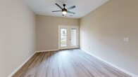 Located at 400 Shelby Station Dr in Louisville, KY, this apartment offers a thoughtfully designed single-floor layout with two bedrooms and two full bathrooms. The open-concept living and kitchen area forms the heart of the unit, where light wood-style flooring flows seamlessly throughout. The living room is bright and welcoming, featuring a ceiling fan, recessed lighting, and a set of glass French doors that invite natural light and provide outdoor access. The kitchen is outfitted with crisp white shaker-style cabinetry, granite-look countertops, stainless steel appliances including a refrigerator, range, microwave, and dishwasher, and a peninsula that connects to the living space. Both bedrooms are comfortably sized with neutral warm-toned walls and windows that bring in natural light. The primary bedroom offers a generous layout with a dedicated closet. The bathrooms are finished with white cabinetry, granite-look countertops, and a full tub-shower combo. Clean lines, neutral tones, and consistent flooring throughout create a cohesive, move-in-ready aesthetic that is both functional and modern.