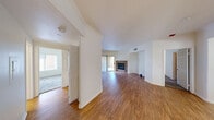 Located at 9550 W Sahara Ave in Las Vegas, NV, this 2-bedroom, 3-bathroom single-floor residence offers a well-organized layout across a comfortable footprint. The welcoming entrance opens into a bright, open-concept living area finished with warm wood-look flooring and crisp white walls. A standout stone-surround fireplace anchors the living room, which also features a sliding glass door leading to an outdoor area, allowing natural light to fill the space. Crown molding and recessed vents add refined touches throughout the common areas. The kitchen is outfitted with white shaker cabinetry, light quartz countertops, a stainless steel double-basin sink, and a stainless steel dishwasher. A curved breakfast bar divides the kitchen from the main living area, creating a practical and social flow. Both bedrooms are carpeted for comfort and receive natural light through window treatments. The generously sized primary bedroom connects directly to its own bathroom, featuring a white vanity and mirror. The additional bedrooms are well-proportioned, each with ample natural light. The three bathrooms maintain a consistent, clean aesthetic with white cabinetry and wood-look flooring. Two closets and a dedicated hallway provide practical storage solutions throughout the home.