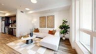Located at 1200 S Grand Ave in Downtown Los Angeles, this modern one-bedroom, one-bathroom residence offers a thoughtfully designed open-concept layout with contemporary finishes throughout. Wood-look flooring flows seamlessly across the living, dining, and kitchen areas, creating a cohesive and stylish aesthetic.

The kitchen is well-appointed with dark cabinetry, quartz countertops, a tile backsplash, and a full suite of stainless steel appliances, including a gas range, microwave, dishwasher, and refrigerator. The adjacent dining area accommodates a full-sized table, making it ideal for both everyday meals and entertaining.

The living room is bright and airy, with large windows that frame views of the surrounding cityscape and fill the space with natural light. A private balcony extends the living area outdoors, offering a relaxing retreat above the city. The bedroom features carpeted flooring, a dedicated closet, and a window with urban views. In-unit laundry adds everyday convenience.

The bathroom is finished with a dark wood vanity, quartz countertop, and wood-look tile flooring, maintaining the home's clean, modern character throughout. This residence delivers an efficient and refined urban living experience in one of LA's most dynamic neighborhoods.