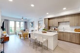 Located at 425 Centerpointe Circle in Altamonte Springs, FL, this well-appointed 2-bedroom, 2-bathroom residence offers a thoughtfully designed single-floor layout with a bright, open-concept living area. Light wood-tone flooring flows throughout, complemented by recessed lighting and a ceiling fan that enhance the airy ambiance.

The kitchen is a standout feature, showcasing warm wood cabinetry, a linear tile backsplash, stainless steel appliances, and a generous white quartz waterfall island with bar seating — seamlessly connecting to the dining and living areas. Sliding glass doors from the living room open to a private balcony overlooking a beautifully landscaped courtyard.

The spacious primary bedroom features large windows with outdoor views, a tray ceiling, and a dedicated closet. The second bedroom is equally well-lit with courtyard-facing windows. Both bathrooms are finished with marble-style tile flooring, wood-tone vanities, and clean white countertops, with one featuring a tub-shower combination.

Additional spaces include a laundry room, utility room, and two closets. The overall design balances modern aesthetics with functional comfort, making this a refined and practical living space in a contemporary multi-story community setting.