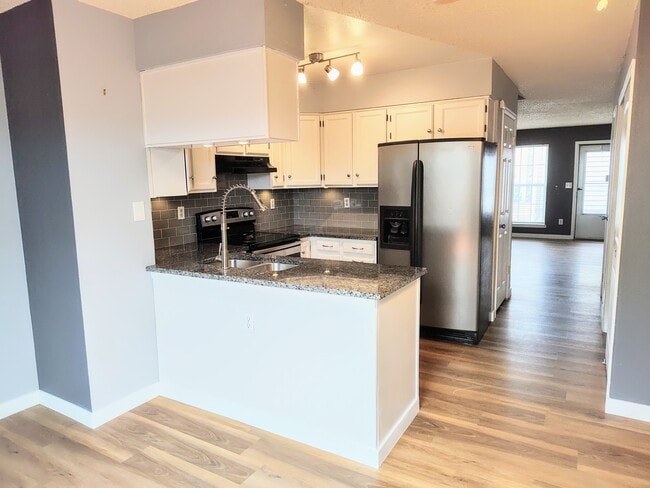 Updated kitchen with stainless steel appliances. - 10856 Bayfield Way