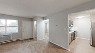 Located at 1699 Shanley Dr in Columbus, Ohio, this single-floor unit offers a practical and well-organized layout designed for comfortable everyday living. The main living area is generously sized, featuring neutral-toned carpet flooring, soft gray walls, and a baseboard heating system. Natural light filters in through windows, contributing to a bright and airy atmosphere. A window-mounted air conditioning unit ensures year-round comfort.

The kitchen stands out as a highlight of the space, featuring dark espresso-toned shaker-style cabinetry with brushed nickel hardware, marble-look countertops, and a full suite of stainless steel appliances, including a refrigerator, electric range, dishwasher, and built-in microwave. Light wood-style vinyl flooring completes the modern aesthetic of this well-appointed kitchen.

The bedroom is a comfortable, carpeted room with a window offering outdoor views and a baseboard heater. Additional rooms provide flexible space, also finished with matching carpet and neutral walls. The bathroom is cleanly appointed with wood-look vinyl flooring, a white vanity, and a full tub and shower combination. The entry area connects seamlessly to the living spaces, offering a welcoming and efficient flow throughout the unit.