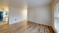 This 690 square foot single-story residence offers a thoughtful layout with two bedrooms and one bathroom. The living areas showcase a modern aesthetic with a mix of flooring types. The main living space features durable hardwood floors, creating an open and inviting atmosphere. Large windows in this area provide abundant natural light and views of the surrounding greenery.

The kitchen, while compact, is efficiently designed with white cabinetry, contrasting countertops, and stainless steel appliances. It opens to a space that could serve as a dining area or extension of the living room, enhancing the home's functionality.

Both bedrooms are carpeted for comfort, with the primary bedroom measuring a spacious 150 square feet. The shared bathroom presents a clean, contemporary design with a combination tub-shower, single vanity, and wood-look flooring that complements the overall interior.

Throughout the home, neutral wall colors and simple light fixtures contribute to a bright, airy feel. The property also features modern amenities such as a ceiling fan and updated HVAC controls, ensuring year-round comfort in this well-appointed Portland residence.