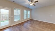 Located at 2655 Andover Hill Way in Knoxville, TN, this two-story home offers three bedrooms and three bathrooms spread across two well-organized floors. The main level features an open-concept kitchen and living area finished with warm hardwood flooring. The kitchen is a standout, boasting white shaker cabinetry, granite countertops with a tile backsplash, a center island with an undermount sink and pendant lighting, and stainless steel appliances. A hallway and staircase with carpet treads and crisp white railings connect the main level to the upper floor. The attached garage provides added convenience with an automatic opener. Upstairs, the generously sized primary bedroom offers plush carpeting and its own bathroom, which includes a granite-topped vanity, tub/shower combo, and marble-style tile flooring. Additional bedrooms are carpeted and naturally lit with large windows. A dedicated laundry room with full-size washer and dryer hookups and a water heater is also found on the upper level. Throughout the home, neutral tones, clean white trim, and consistent finishes create a cohesive, move-in-ready aesthetic.