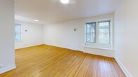 Located at 21 Arnold Park in Rochester's desirable 14607 zip code, this 3-bedroom, 1-bathroom unit offers a practical and comfortable single-floor layout. Warm-toned hardwood floors run throughout the living areas and all three bedrooms, lending a classic and cohesive feel to the space. The living room is bright and welcoming, featuring a large window that draws in natural light, recessed lighting, and clean white walls with white-painted baseboards. Each bedroom is well-proportioned, with the primary bedroom offering a comfortable footprint, hardwood floors, and windows that provide views of the surrounding neighborhood. One bedroom features light tile flooring and dual windows that flood the room with sunlight. The kitchen is efficiently designed with white cabinetry including glass-front upper cabinets, dark granite-style countertops, white tile flooring, a gas range, built-in microwave, dishwasher, and a window above the sink for added brightness. The full bathroom is finished with classic white basketweave mosaic floor tile, a full soaking tub with shower, and a window for natural ventilation. A hallway connects the rooms, completing this well-organized and functional floor plan.
