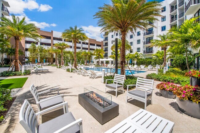 Gather around the firepit and enjoy inviting outdoor spaces day or night. - SoLe Mia Rentals