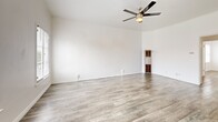 Located at 323 E Lomita Ave in Glendale, California, this thoughtfully laid-out one-bedroom, two-bathroom unit offers a clean, modern aesthetic across a single floor. Light-toned wood-look flooring runs throughout, lending a cohesive and bright feel to the entire space.

The living room is generously proportioned, featuring crisp white walls, a ceiling fan with light fixture, and natural light filtering in through blinds-covered windows. Adjacent to the living area, the kitchen is equipped with stainless steel appliances including a gas range and a full-size refrigerator, white cabinetry with a display shelf, and a neutral countertop — all well-lit by overhead track lighting.

The bedroom benefits from multiple windows that invite in natural light and offer views of the surrounding neighborhood. A built-in white dresser with a wall-mounted mirror and a sliding closet door provide practical storage solutions.

The standout bathroom showcases retro charm with bold mint-green ceramic tile wainscoting accented by black trim, classic hex-tile flooring with floral details, and a bright window for ventilation. A second bathroom adds convenience for guests.

Overall, the space presents a clean, move-in-ready interior that blends modern updates with timeless vintage character.