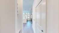 Located at 2351 Plaza Blvd in Richardson, TX, this two-bedroom, three-bathroom single-story unit offers a well-designed open floor plan with contemporary finishes throughout. Light-toned wood-style flooring runs through the main living areas, complementing the bright, neutral color palette that defines the interior.

The kitchen is a standout feature, equipped with stainless steel appliances, dark wood cabinetry with a subway tile backsplash, quartz countertops, and a center island with an undermount sink accented by pendant lighting. The kitchen flows seamlessly into the living area, which benefits from generous natural light and direct access to a private balcony through tall glass doors, offering open views of the surrounding Richardson cityscape.

Both bedrooms are carpeted and include dedicated closet space and en-suite or adjacent bathroom access. The bathrooms feature wood-toned vanities with white quartz countertops and light hardwood-style tile flooring. The primary bathroom includes a full soaking tub and shower combination, while a secondary bathroom offers a clean, functional layout. Two closets provide additional storage throughout the unit.