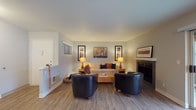 Located at 14310 SW Teal Blvd in Beaverton, Oregon, this single-floor residence offers a well-organized and thoughtfully designed layout. The living room serves as the heart of the home, showcasing wood-look flooring, a fireplace with a clean white surround, and a sliding glass door that opens to an outdoor patio, filling the space with natural light and greenery views. Framed artwork and warm ambient lighting contribute to a welcoming atmosphere.

The kitchen is outfitted with white shaker-style cabinetry, granite-toned countertops, stainless steel appliances including a refrigerator, range, microwave, and dishwasher, and track lighting overhead. One kitchen configuration features a peninsula with a sink, providing additional prep space and an open connection to the living areas.

The dining area accommodates a round table and is surrounded by multiple windows and a sliding door, offering pleasant outdoor views and abundant natural light. A ceiling fan adds comfort to the space.

The bedrooms are carpeted and serene, each featuring closets with panel-style doors. The primary bathroom includes white cabinetry, a granite-toned vanity countertop, and a large mirror with modern lighting. A second full bathroom offers a shower-tub combination. Wood-look flooring flows consistently throughout the main living areas, tying the home together cohesively.