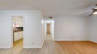 This well-appointed 2-bedroom, 2-bathroom residence at 2800 Paces Ferry Rd SE in Atlanta, Georgia offers a thoughtfully designed single-floor layout. The living room is bright and open, featuring light hardwood-style flooring, a ceiling fan, and French doors that invite natural light and provide access to an outdoor balcony area. The kitchen is outfitted with white shaker-style cabinetry, granite countertops, a gray subway tile backsplash, and a full suite of stainless steel appliances, including a refrigerator, electric range, and built-in microwave. Both bedrooms are carpeted and feature ceiling fans and natural light from windows with blinds. The spacious primary bedroom includes a walk-in closet with built-in wire shelving. The second bedroom offers a double-door closet for ample storage. The bathrooms are finished with wood-look flooring, granite vanity tops, and a tiled tub-surround with brushed nickel fixtures. A dedicated laundry area with a full-size washer and dryer adds everyday convenience. Two closets throughout the home provide generous storage, rounding out a functional and comfortable living space.